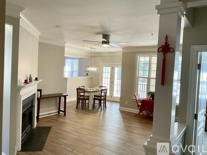 A living room with a fireplace and a dining table.