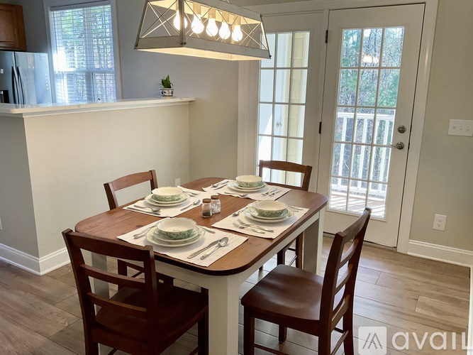 A dining room with a table set for a meal.