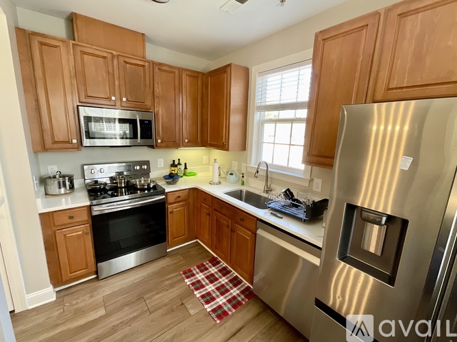 A kitchen with wooden cabinets and stainless steel appliances.