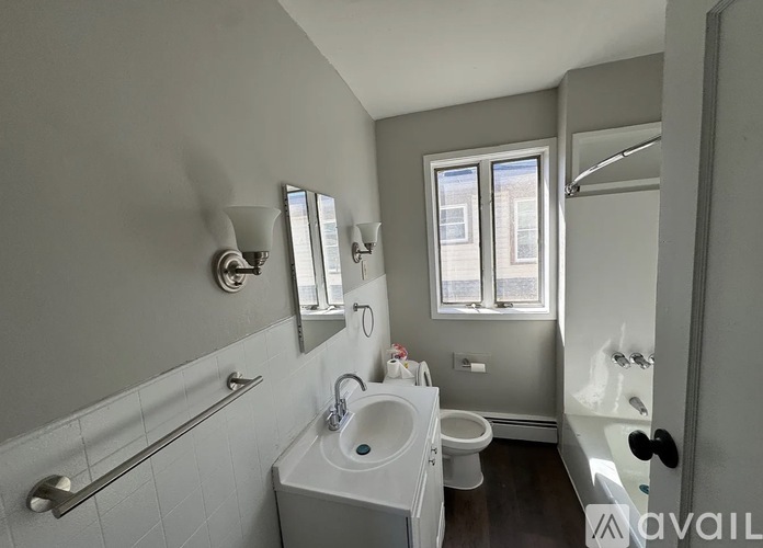 A bathroom with a white sink, toilet, and bathtub.
