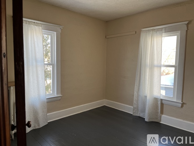 A room with two windows and a door.