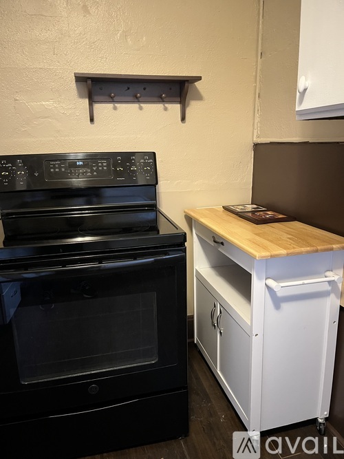 A black oven and a white dishwasher in a kitchen.