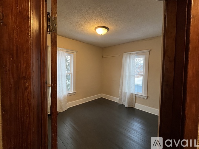 A room with a window and a door.
