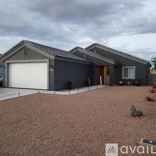 A house with a grey roof and a white garage door.