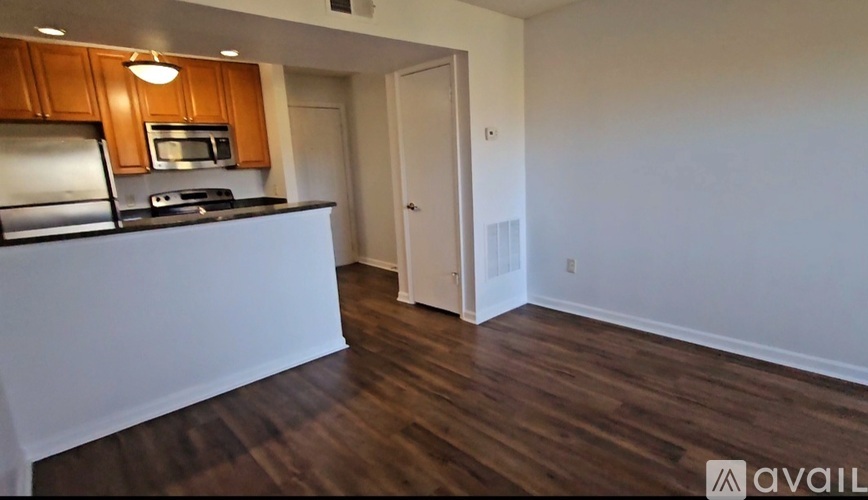 A kitchen with wooden cabinets and a white countertop.