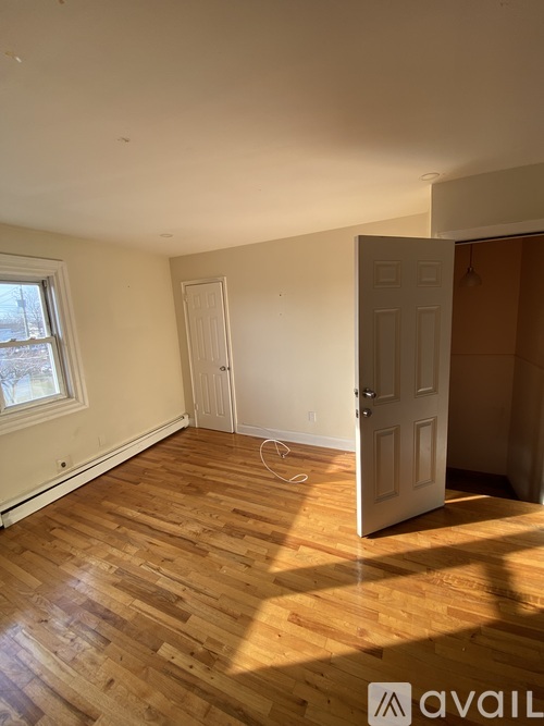 A room with wooden floors and white walls.