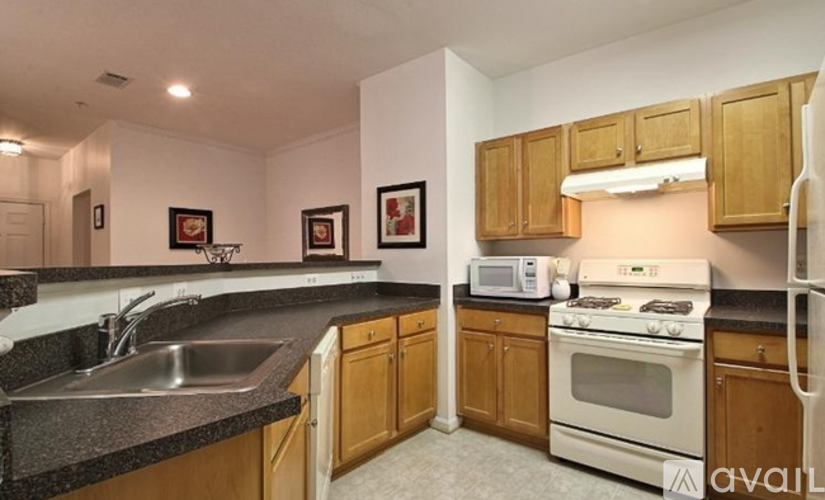 A kitchen with wooden cabinets and a white oven.