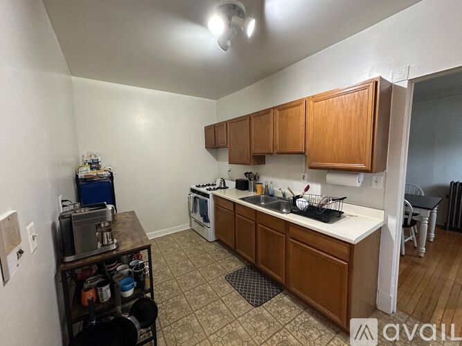 A kitchen with wooden cabinets and a white countertop.