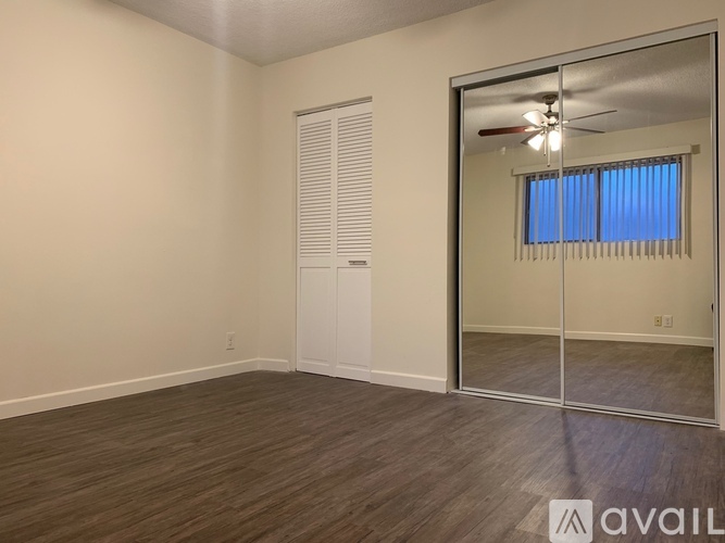 A room with a sliding glass door leading to a balcony.