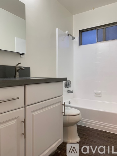 A bathroom with a toilet, sink, and bathtub.