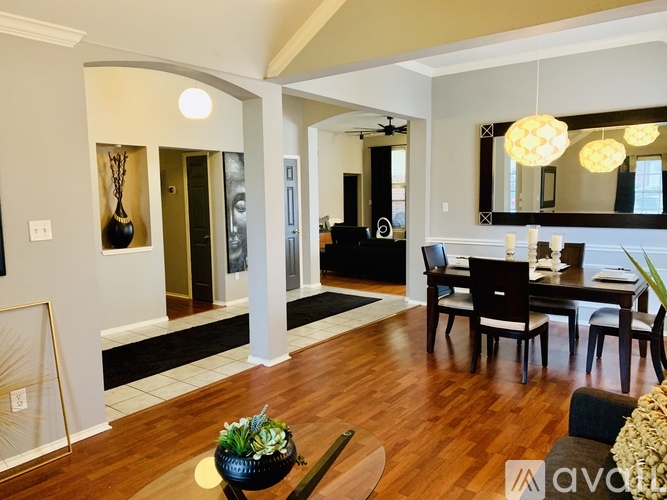 A modern living room with a dining table and chairs.