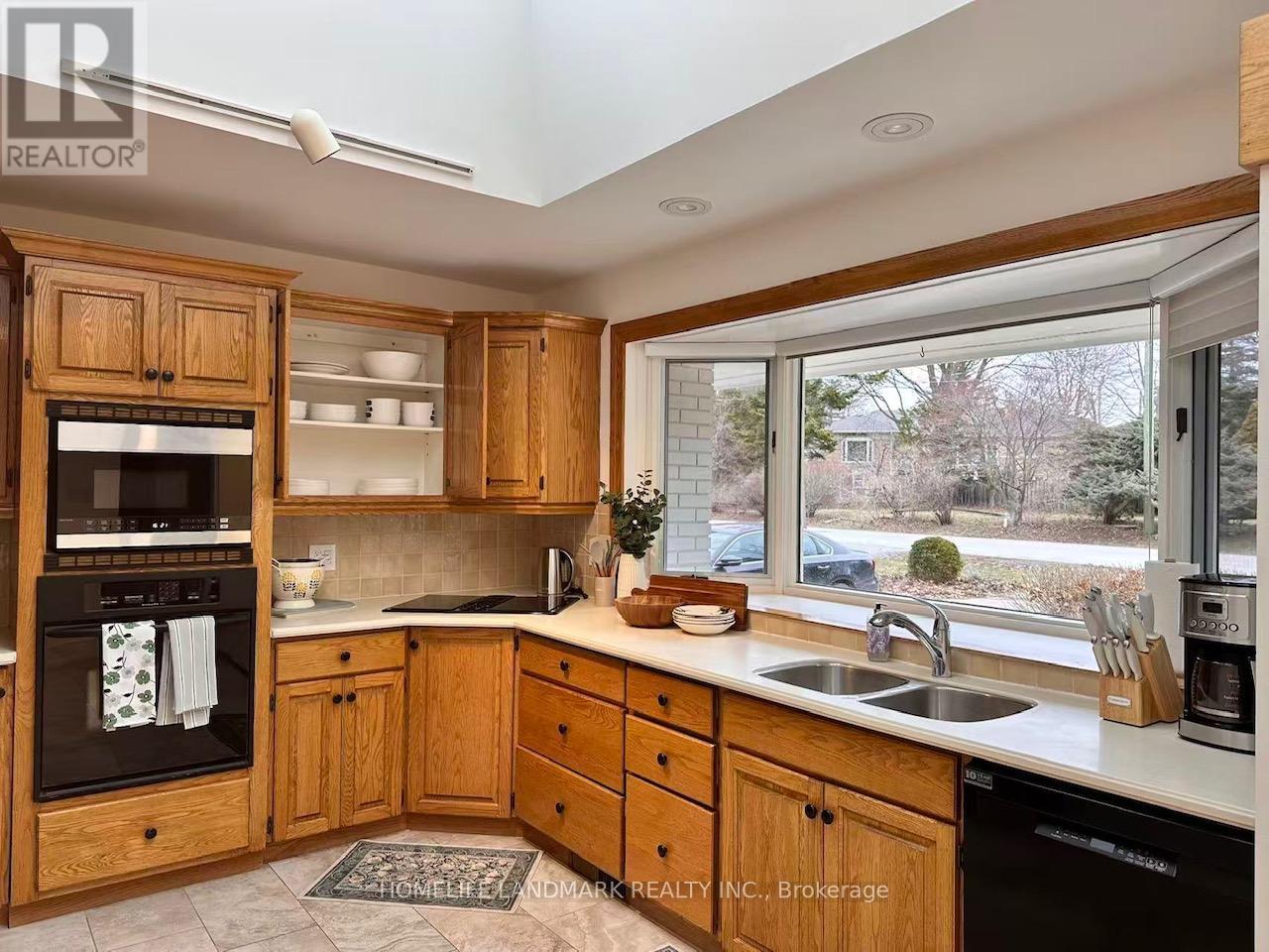 A kitchen with wooden cabinets and appliances.