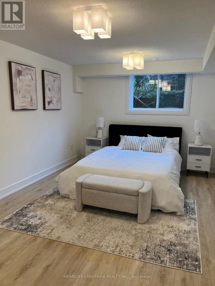 A bedroom with a large bed and a rug on the floor.