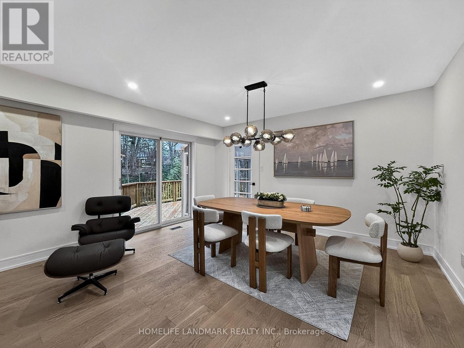 A dining room with a wooden table and chairs.