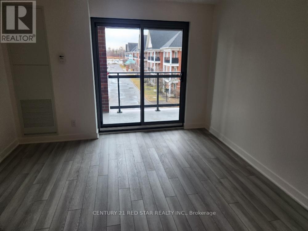 A room with a view of a street through a glass door.