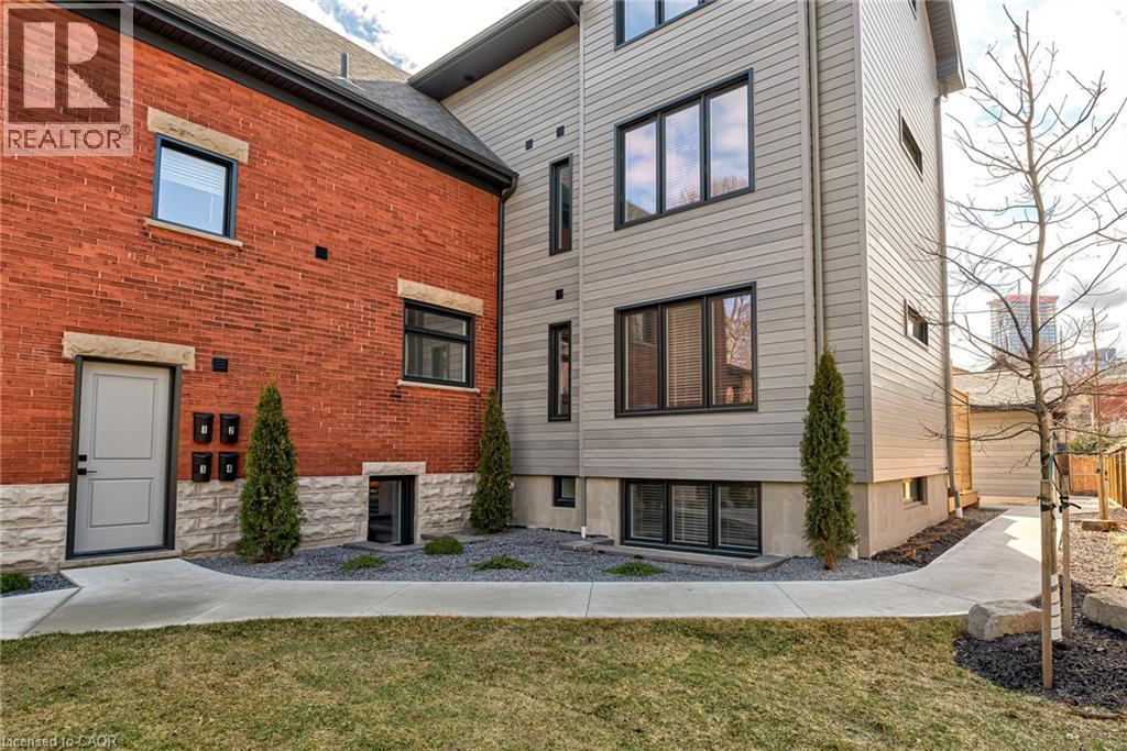 A modern house with a brick and wood exterior is for sale.