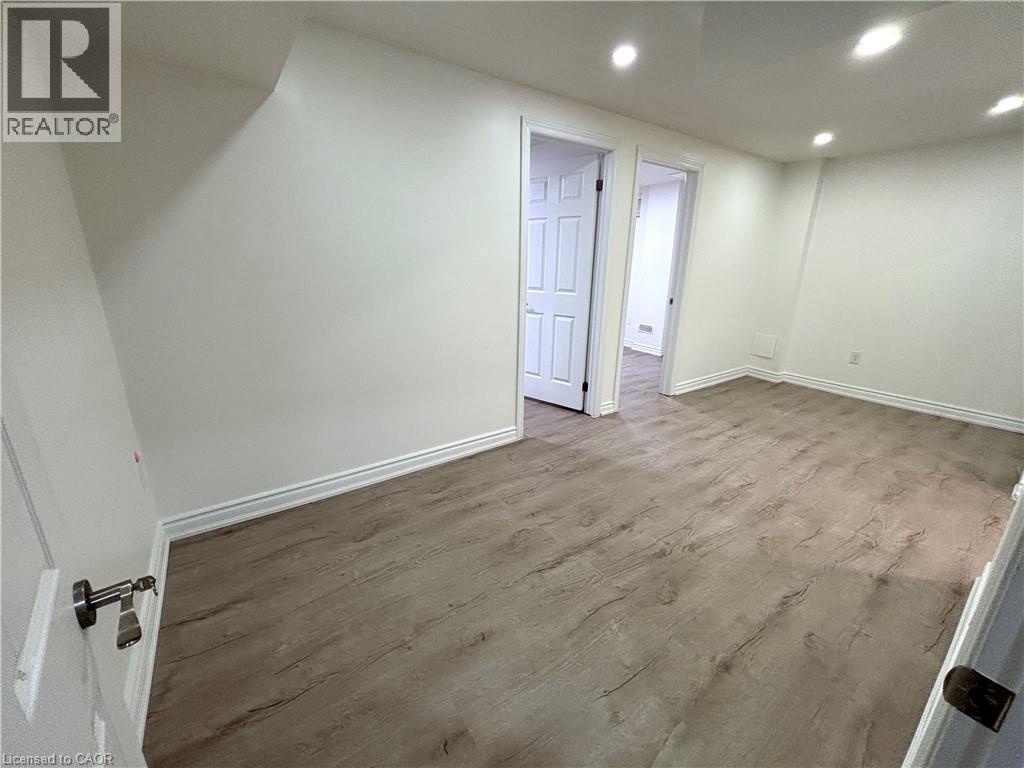 A room with wood flooring and white walls.