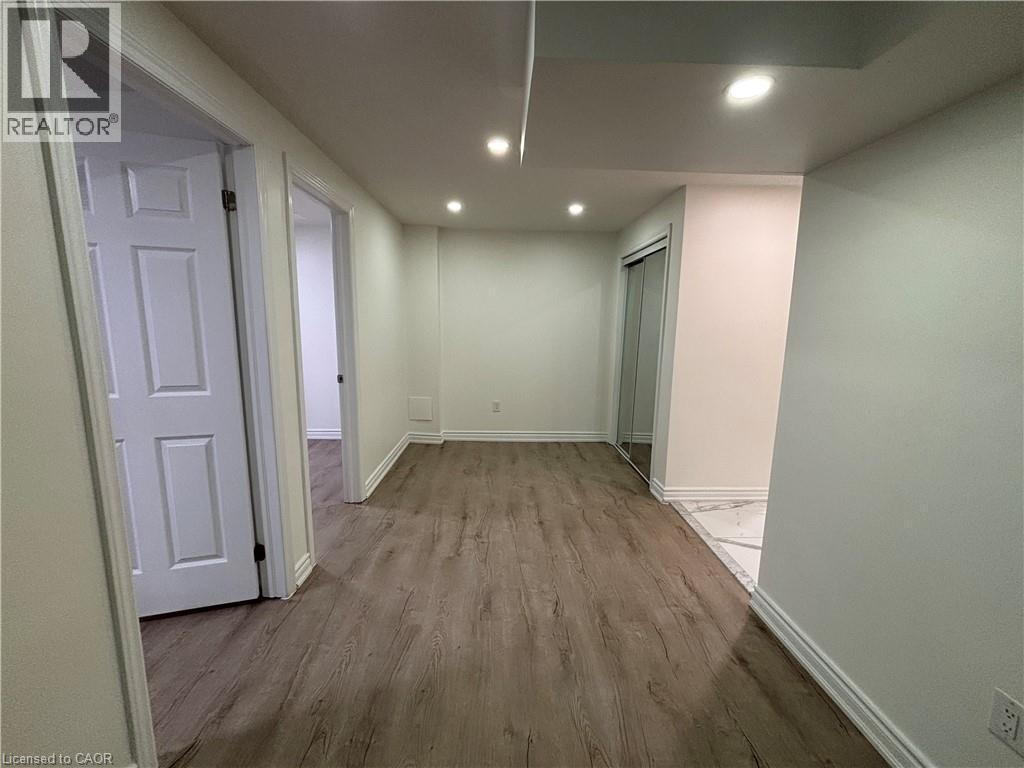 A room with wooden flooring and white walls.