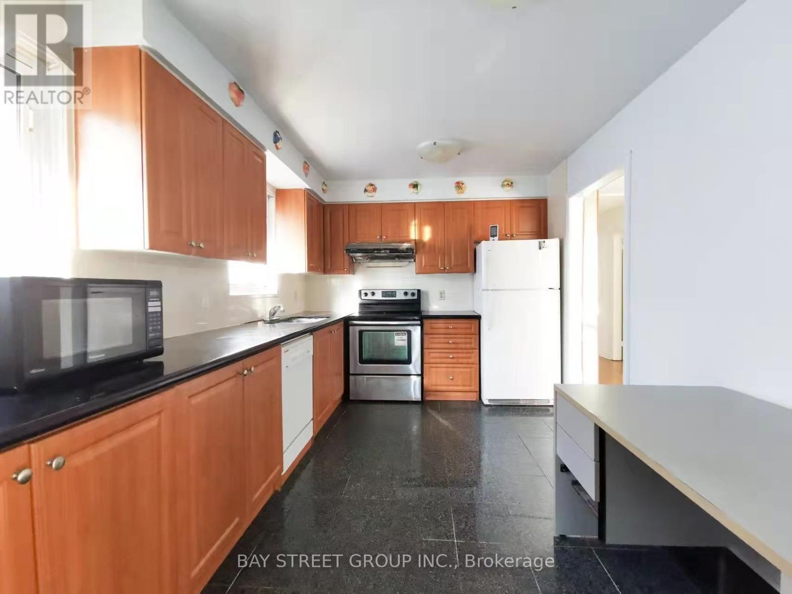 A kitchen with wooden cabinets and a white refrigerator.