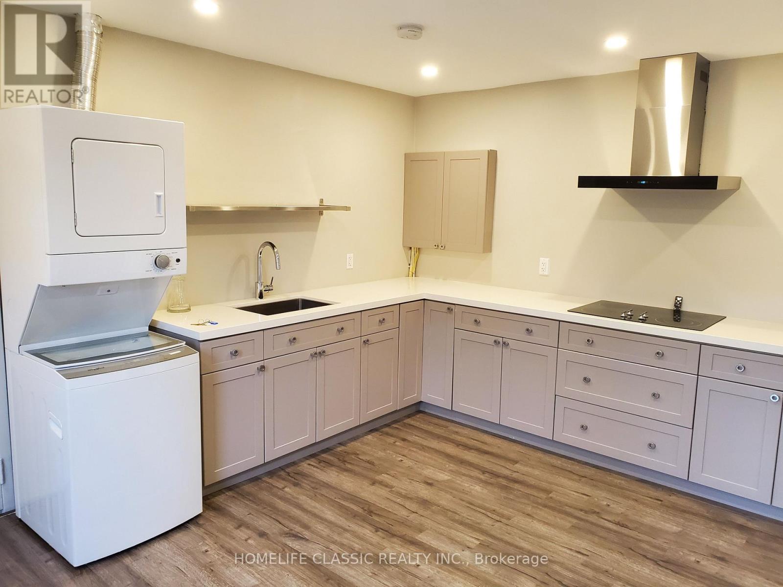 A kitchen with white appliances and cabinets.