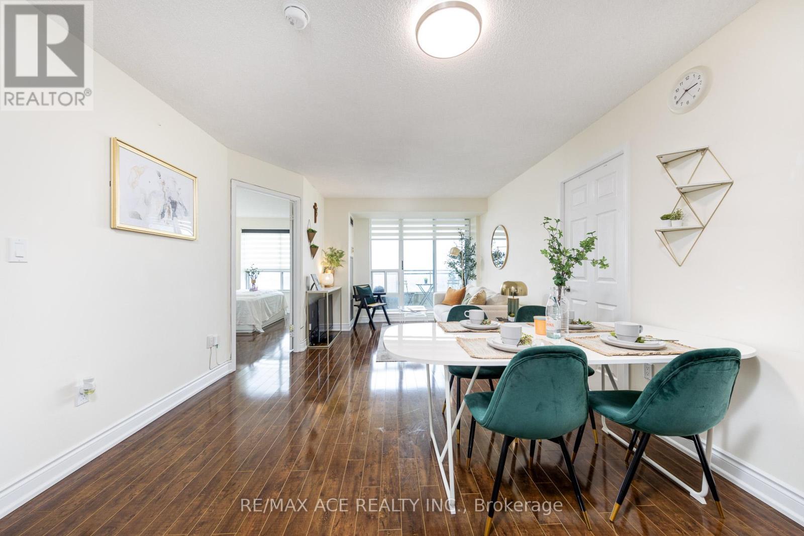 A dining room with a table set for two and a white wall.