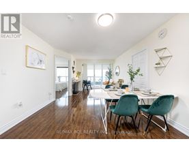A dining room with a table set for two and a white wall.