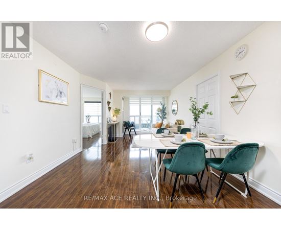 A dining room with a table set for two and a white wall.