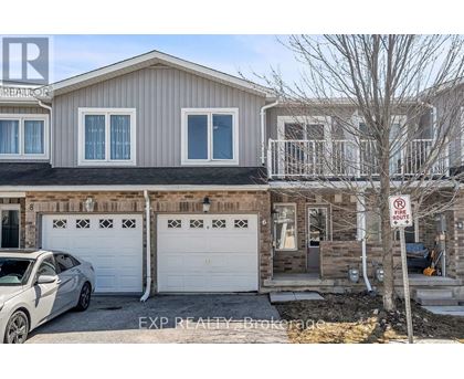 A two-story house with a garage and a car parked in front.