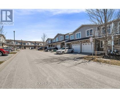 A street view of a residential area with houses and parked cars.