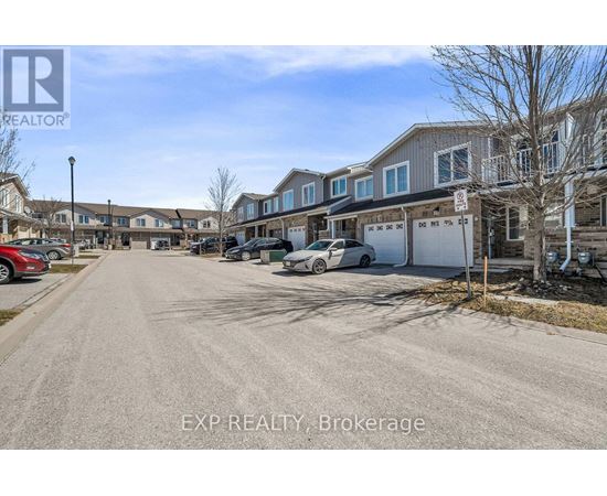 A street view of a residential area with houses and parked cars.