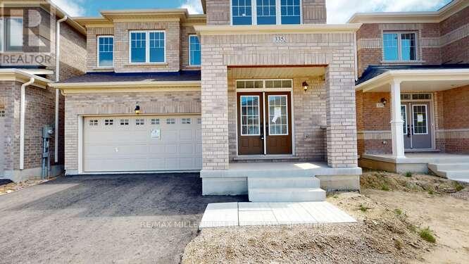 A house with a garage and a driveway in front.