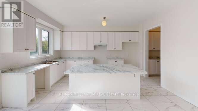 A bedroom with a bed, a counter, and a window.