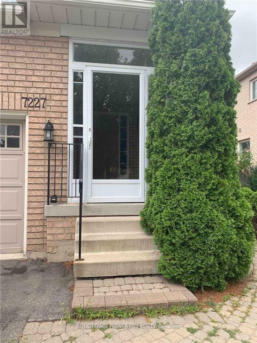 A white door with a black handle is on a brick house.