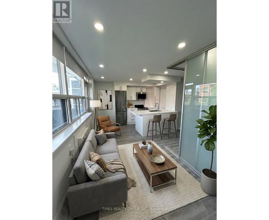 A modern living room with a grey sofa and a wooden coffee table.