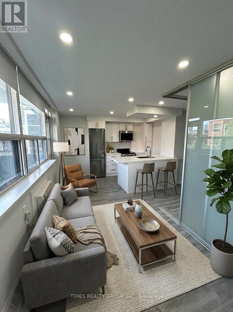 A modern living room with a grey sofa and a wooden coffee table.