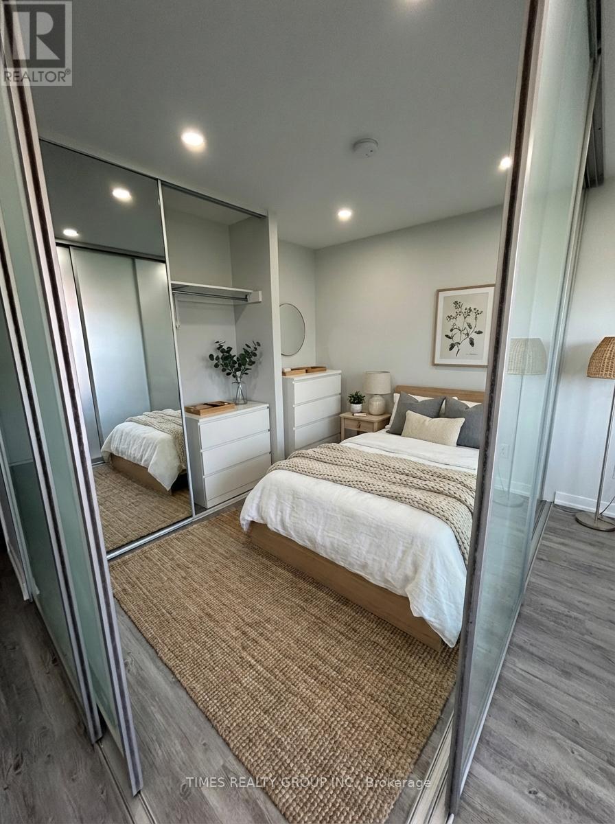 A bedroom with a large bed and a mirror on the wall.