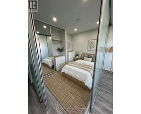 A bedroom with a large bed and a mirror on the wall.