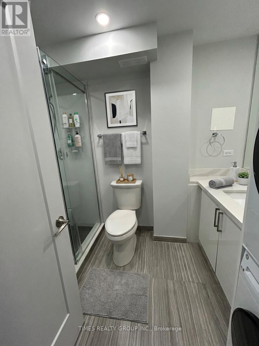 A bathroom with a toilet, sink, and mirror.