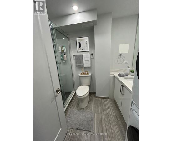 A bathroom with a toilet, sink, and mirror.