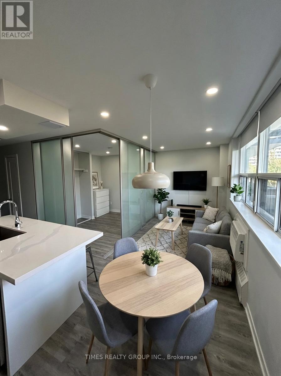 A modern kitchen with a dining table and chairs.