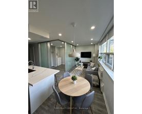 A modern kitchen with a dining table and chairs.