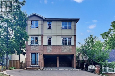 A two-story house with a garage is for sale.