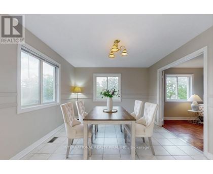 A dining room with a table set for four.