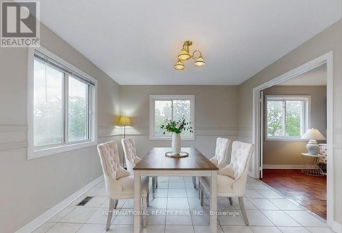 A dining room with a table set for four.