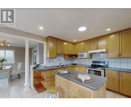 A kitchen with wooden cabinets and a countertop with a plate on it.