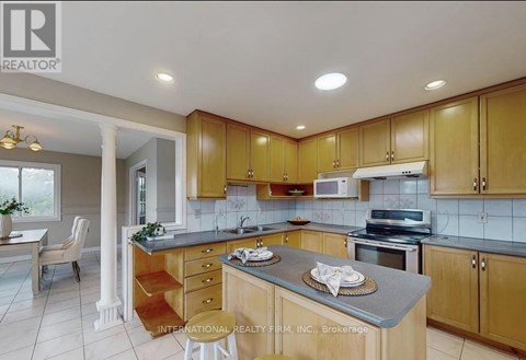 A kitchen with wooden cabinets and a countertop with a plate on it.