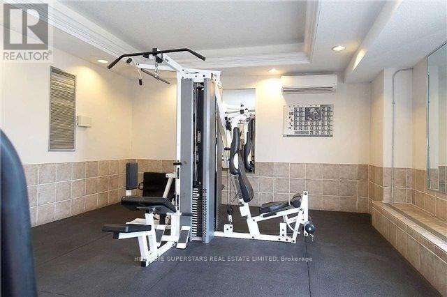 A home gym with a weight machine, bench, and mirror.