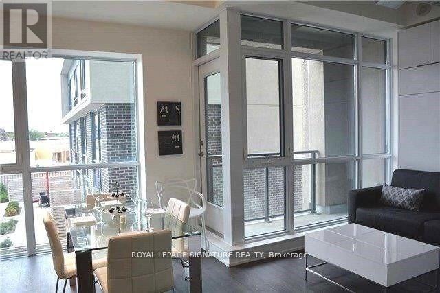 A modern living room with a glass table and chairs.