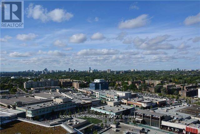 A realtor photo of a cityscape with buildings and a cloudy sky.