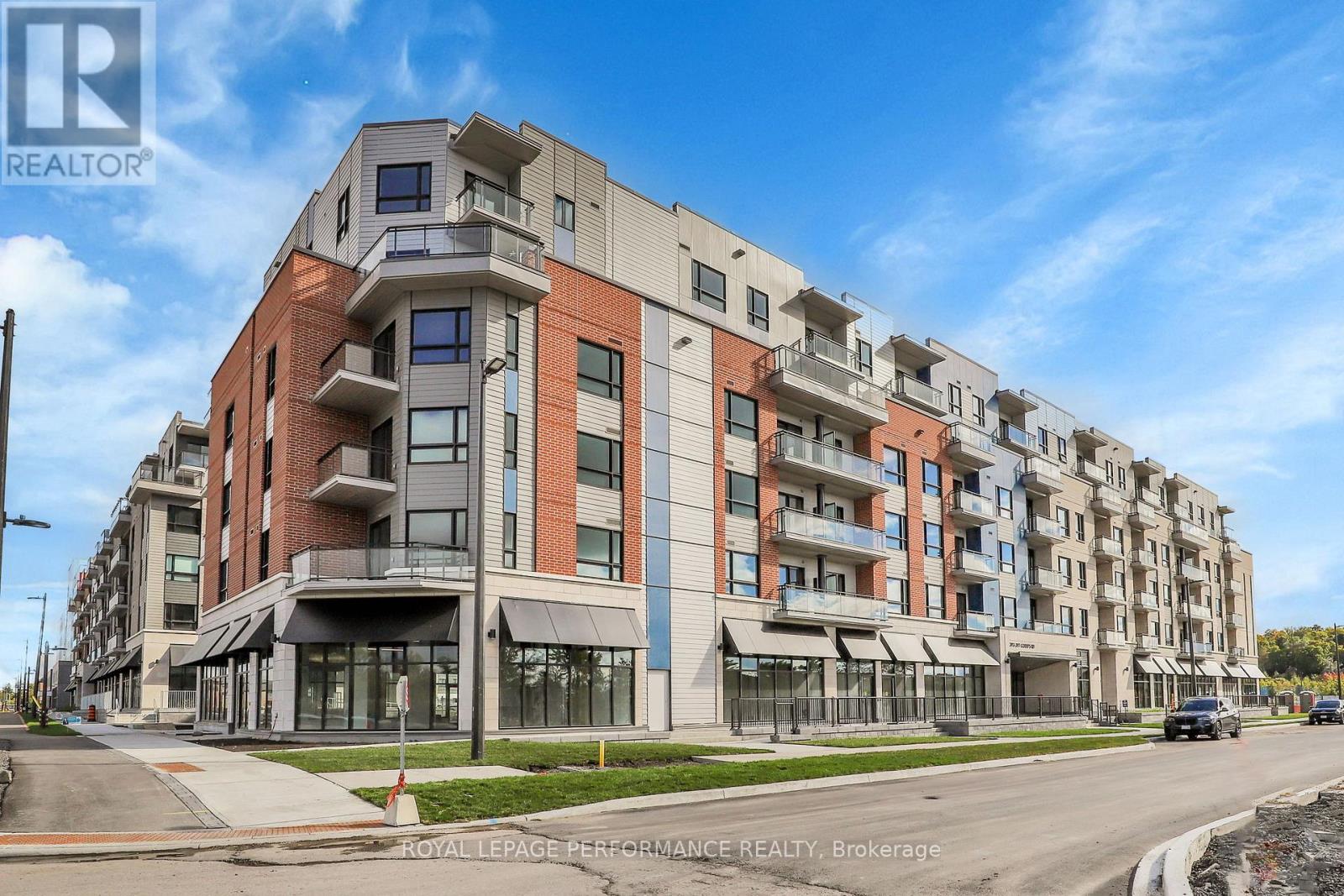 A multi-story apartment building with a clear blue sky above.